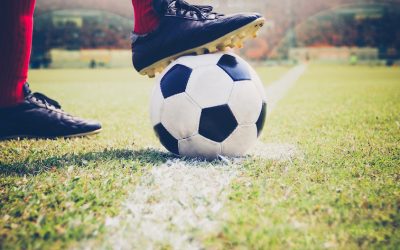 soccer or football player standing with ball on the field for Kick the soccer ball at football stadium,Soft focus